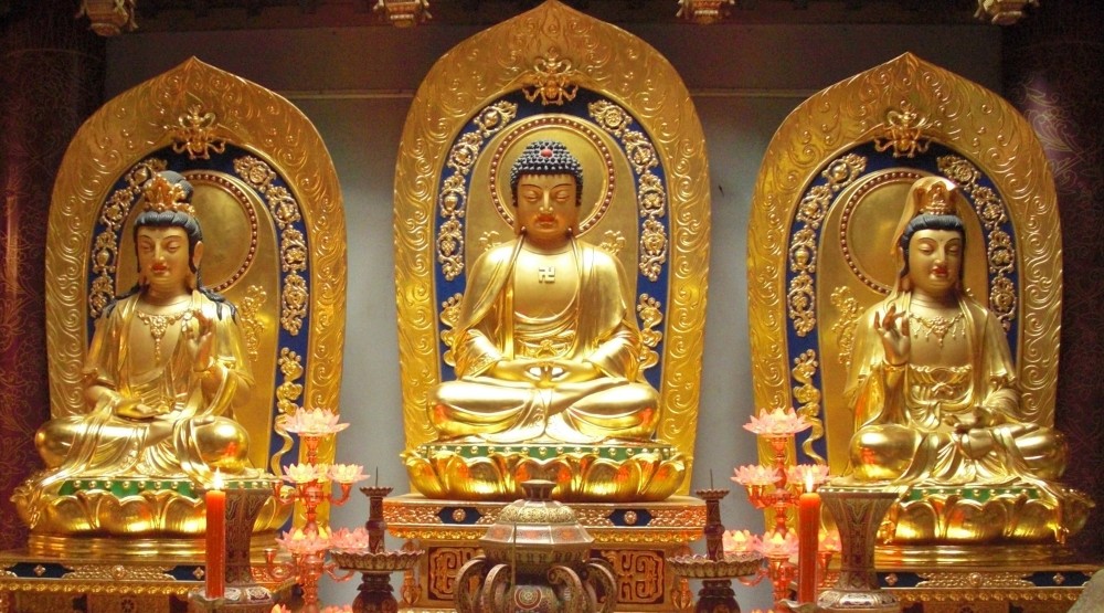 A Chinese shrine to the Buddha Amitabha. Amitabha is worshiped by Pure Land Buddhists, who pray to be reincarnated in his "pure land" of Sukhavati, where there is no pain or temptation and attaining enlightenment is easy. In Buddhist scripture, Sukhavati is said to be located in a remote part of our own universe, "ten myriads of a hundred millions of buddha-lands to the west." Does this indicate that Amitabha Buddha is an extraterrestrial? (photo credit: <a href="http://commons.wikimedia.org/wiki/File:Amitabha_Buddha_and_Bodhisattvas.jpeg">Tengu 800</a> )