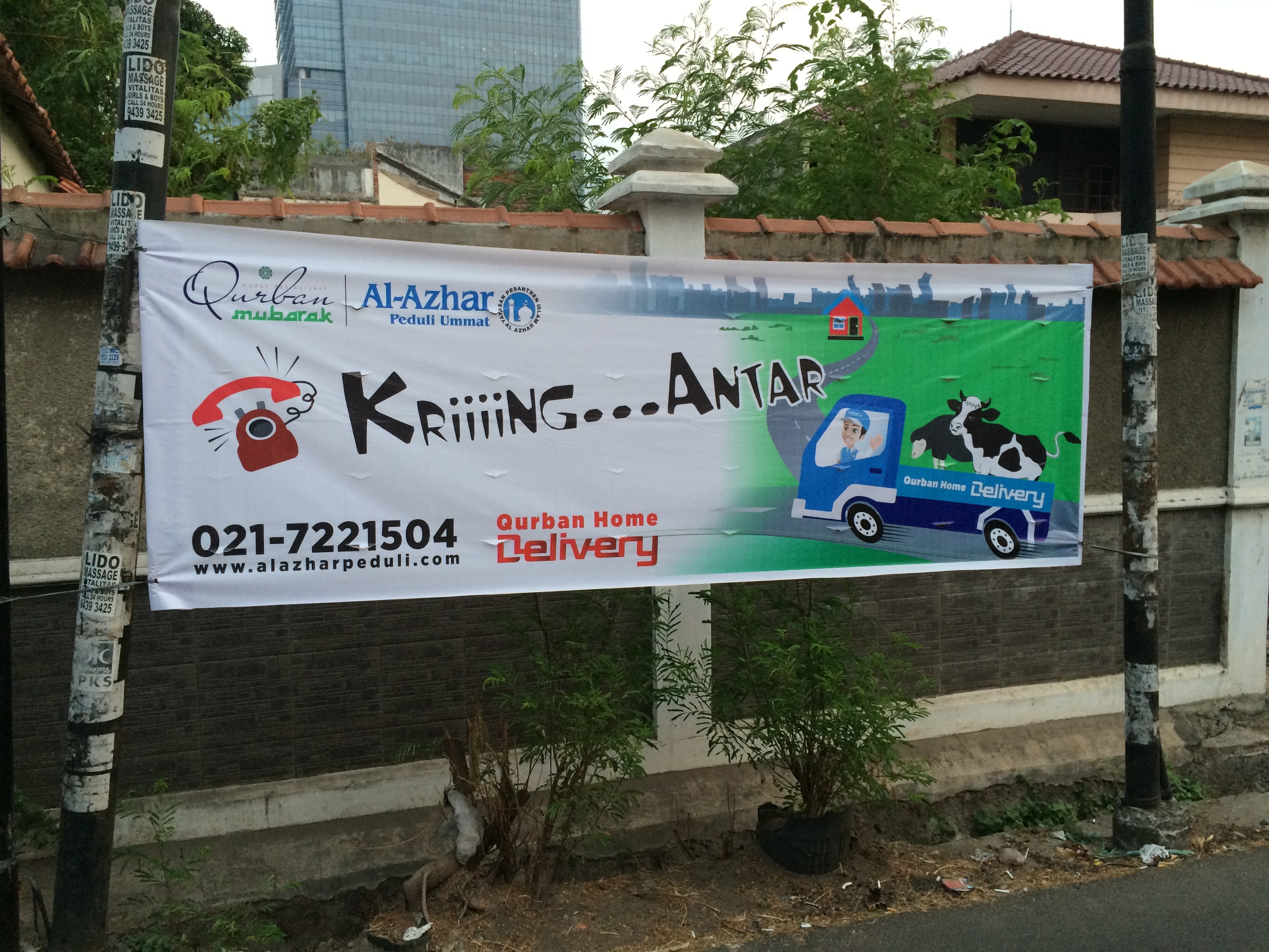 Banner in Jakarta, Indonesia advertising home delivery of animals for slaughter
